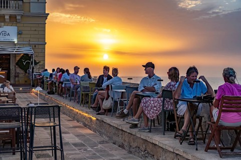 Restaurant by the water at sunset, Gallipoli, Apulia, Italy