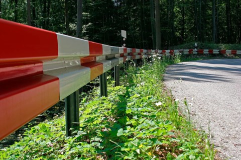 Crash barrier on the road, dangerous bend