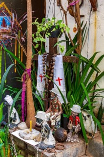 Religious syncretism of Umbanda and Cotolicism mixed on an altar among the plants, Belo Horizonte,