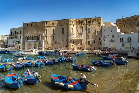 Blue Gozzi fishing boats in the old harbour of Monopoli, Apulia, Italy