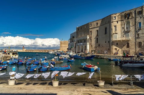 Blue Gozzi fishing boats in the old harbour of Monopoli, Apulia, Italy