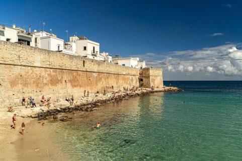 City wall and Cala Porta Vecchia beach in Monopoli, Apulia, Italy