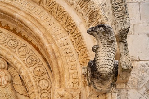 Bird's head above the portal of the church of Santa Maria Maggiore in Monte Sant'Angelo, Gargano,