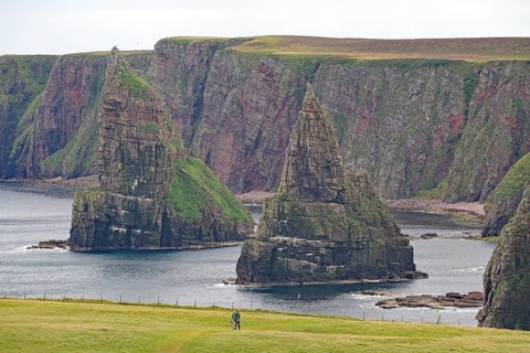 Majestic coastal cliffs surrounded by green grass and the sea, Duncansby Stacks, Thurso, Old Town,