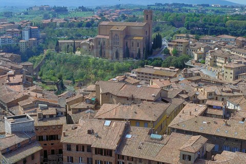 View of the Basilica Di San Dominico, in front of the roofs of the historic centre, Siena, Tuscany,