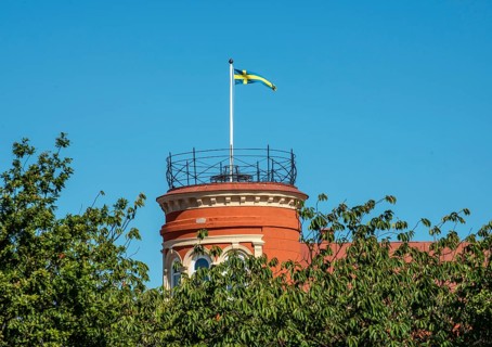 Swedish flag on a tower and at blue sky in Ystad, Skåne county, Sweden, Scandinavie