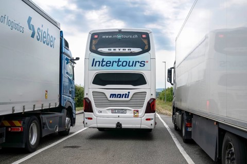 Rest area Bern-Fribourg coach between two lorries, Schmitten, Switzerland