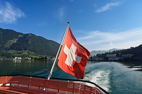 Swiss flag in the stern of the motor ship Brunnen in motion, Lake Lucerne, Brunnen, Canton, Schwyz,