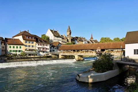 Old town with the tower of the Muri- Amthof, in the foreground the weir, the old wooden bridge over