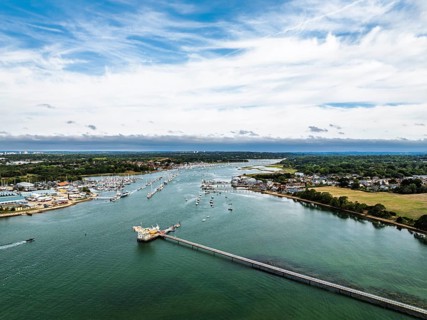 River Hamble over Warsash Maritime Academy Pier from drone, Hamble-le-Rice, Warsash, Southampton