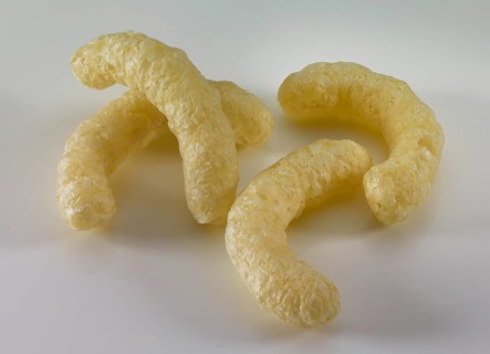 Corn flips, puffed corn snack in front of a white background