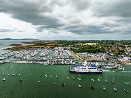 Wight Light car ferry to Isle of Wight on Lymington River and marina from drone, Lymington, New