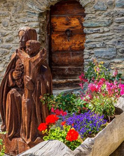 Carved wooden figure of the Virgin Mary with the infant Jesus, wooden trough decorated with