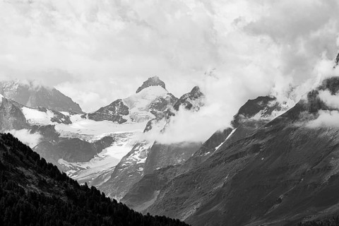 Four-thousand metre mountains and glaciers in clouds, black and white photograph, above Zinal, Val