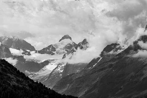 Four-thousand metre mountains and glaciers in clouds, black and white photograph, above Zinal, Val