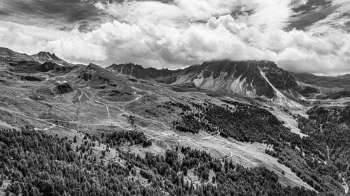 The summit of the Weisshorn enveloped in clouds, alpine pastures above Saint Luc, drone shot, black