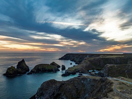 Sunset over Kynance Cove from a drone, Mount's Bay, Lizard Point, Cornwall, England, United Kingdom