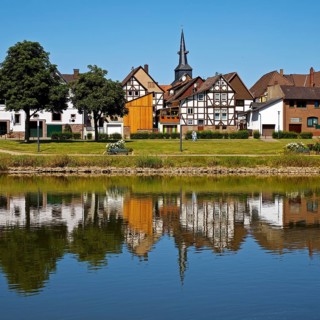 View over the river Weser to the old town centre of Bodenwerder with the church tower of St.