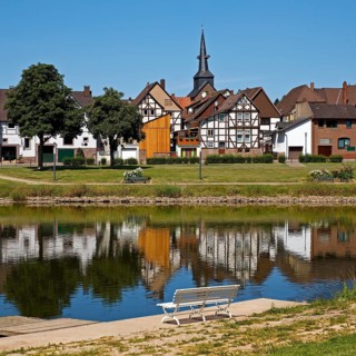 View over the river Weser to the old town centre of Bodenwerder with the church tower of St.