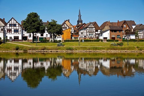 View over the river Weser to the old town centre of Bodenwerder with the church tower of St.