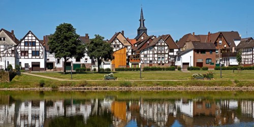 View over the river Weser to the old town centre of Bodenwerder with the church tower of St.