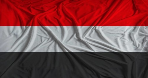 Yemeni flag with fabric texture background. National flag of Yemen with cloth texture