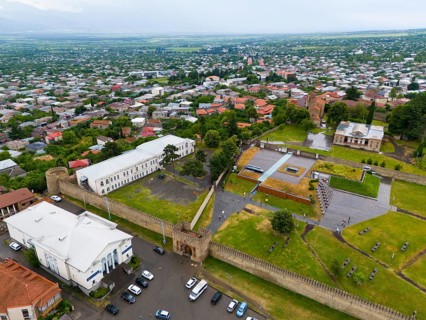 Historic walls and buildings with neighbouring trees in an urban environment, aerial view, bank