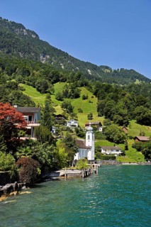 View of the village with the Roman Catholic Church of St Idda, Lake Lucerne in the background,