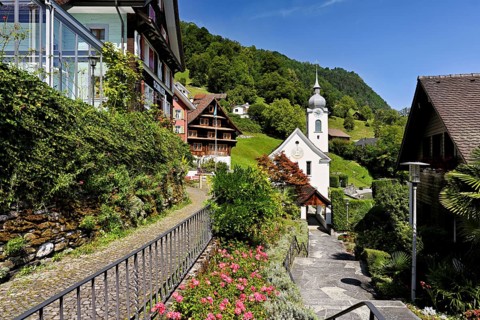 View of the village with the Roman Catholic Church of St Idda, Lake Lucerne, Bauen, Canton, Uri,