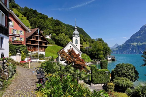 View of the village with the Roman Catholic Church of St Idda, Lake Lucerne in the background,