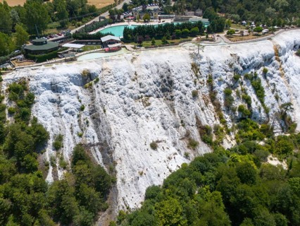 White limestone formation with lush vegetation, geological structure, aerial view, Akkaya