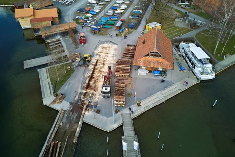 Raft of felled tree trunks at the landing stage where the trunks are pulled ashore and cut to size