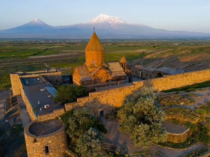 A historic monastery in the morning light in front of Mount Ararat, aerial view, Chor Wirap