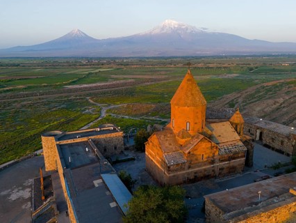 Historical monastery in the morning light with Mount Ararat in the background, aerial view,