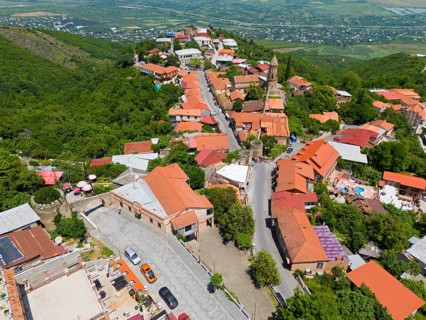 Hilly street view with traditional buildings and panoramic distant view, aerial view, Sighnaghi,