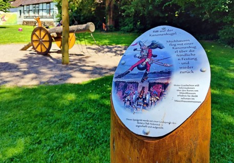Sign of Munchausen's ride on the cannonball on the children's playground in the Munchausen town of