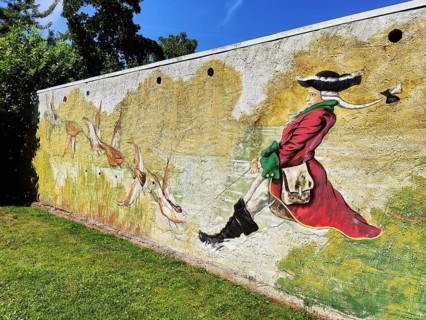 Painting on a wall Münchhausen on a duck hunt in the Münchhausen town of Bodenwerder,