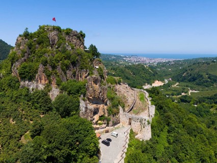 Panorama of a rocky hill with flag and wide valley view, aerial view, Ünye Castle, Ünye Kalesi,