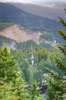 View over a wooded valley with mountain scenery and buildings between the trees, Mummelsee,