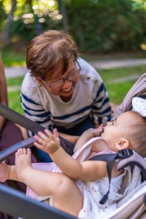Grandmother enjoys a playful moment with her granddaughter, creating a heartwarming scene of family