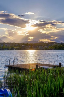 Bathing jetty at sunset on the lake near Neuegg am Faaker See, Carinthia, Austria
