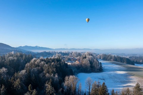 Hot air balloon in winter over Bad Heilbrunn, Upper Bavaria, Bavaria, Germany