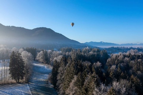 Hot air balloon in winter over Bad Heilbrunn, Upper Bavaria, Bavaria, Germany