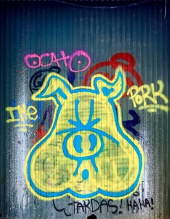 Graffiti as a pig's head on a shop gate in the old town centre of Girona, Cataluña, Gerona,