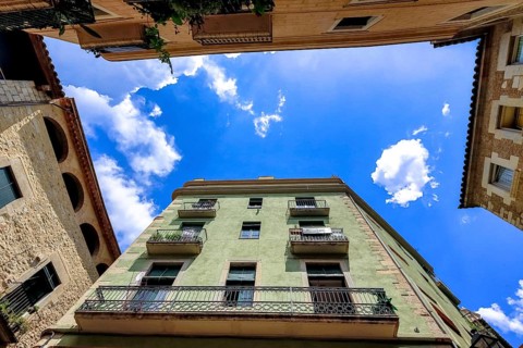 View into the sky between the alleys in the old town of Girona, Cataluña, Gerona, Catalonia, Spain,