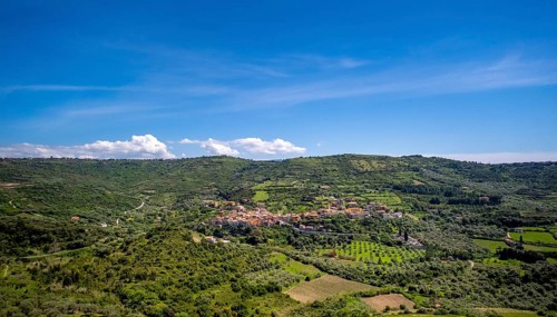 Sardinia, Village view and houses surrounded by meadows and fields, blue sky with clouds, Modolo,