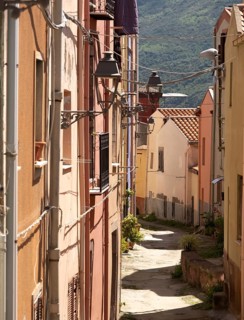 Sardinia, Narrow alley with picturesque house and window with streetlights, Bosa, Europe, Province