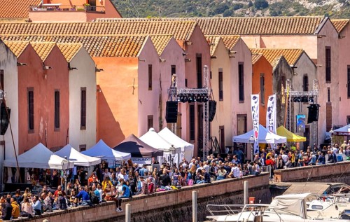 Sardinia, residential buildings on the promenade, guests at the restaurants with outdoor dining,
