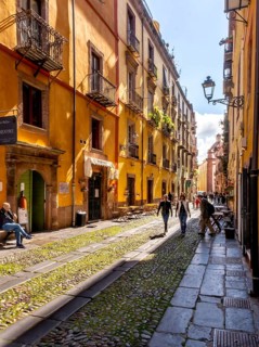 Sardinia, tourists in a pedestrian zone with picturesque house fronts, Bosa, Europe, Province of