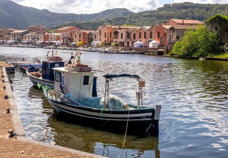 Sardinia, fishing boat in the harbour of Bosa, harbour mile promenade with pavilions and boats on